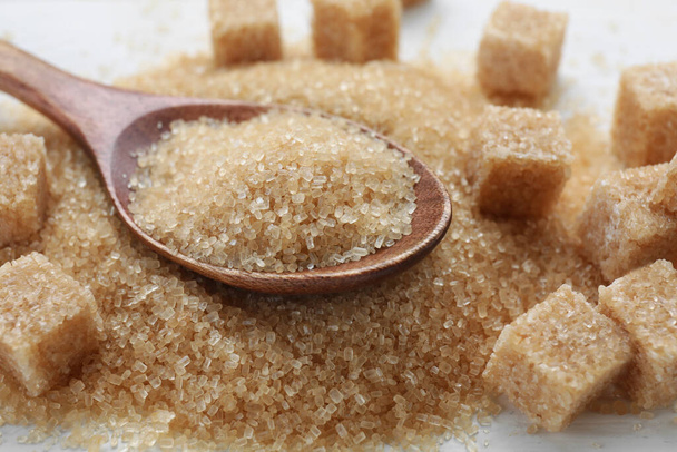 Different types of brown sugar on white table, closeup - Fotoğraf, Görsel
