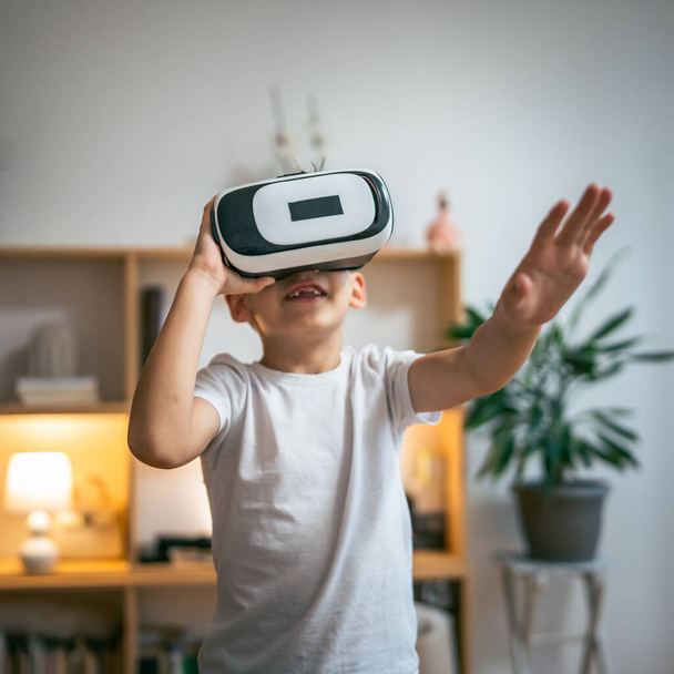 boy male caucasian child at home enjoy virtual reality VR headset - Zdjęcie, obraz