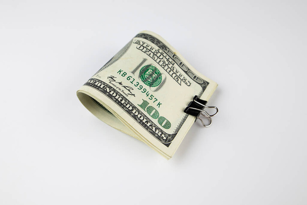 Big Stack of Folded Hundred Dollar Bills Isolated on White Background. Bundle of dollars isolated on white. Close-up. Financial concept. American money. - Photo, Image