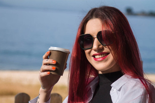 young redhead girl having a coffee outdoors - Zdjęcie, obraz