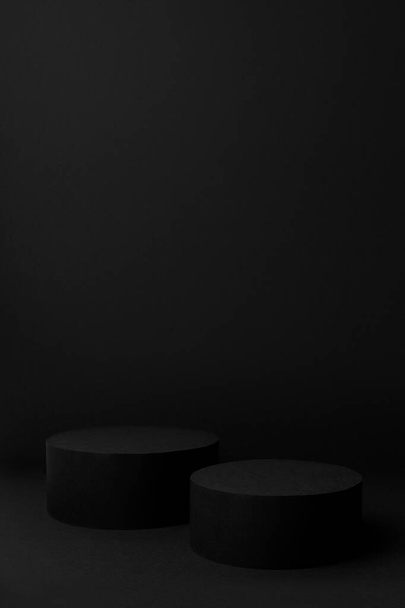 Abstract black scene with two cylinder podiums template for presentation cosmetic products, goods, advertising, design, sale, text in soft gradient, mockup in minimalism style, vertical, copy space. - Foto, immagini
