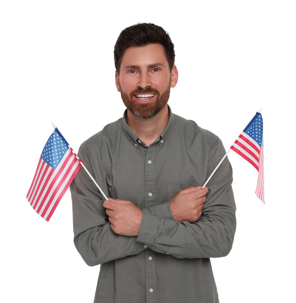 4th of July - Independence day of America. Happy man holding national flags of United States on white background - Foto, immagini