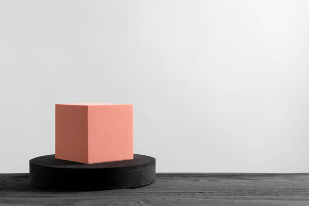 Cube and round shaped podiums on grey wooden table. Space for text - Fotó, kép