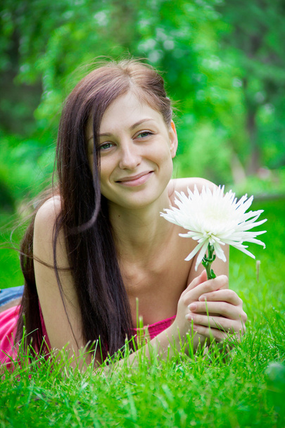 Brunette with a flower - 写真・画像
