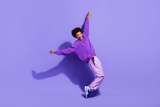 Full body cadre of funky millennial guy dance tiptoes crazy party discotheque clubbing boogie woogie isolated on purple color background. - Photo, Image