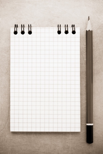 Checked notebook at metal background - Zdjęcie, obraz