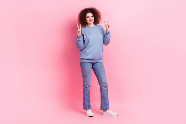 Full length photo of sweet cheerful lady wear blue sweatshirt showing two v-signs isolated pink color background. - Foto, immagini
