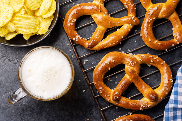 Freshly baked homemade pretzels and draft beer. Flat lay - Photo, Image