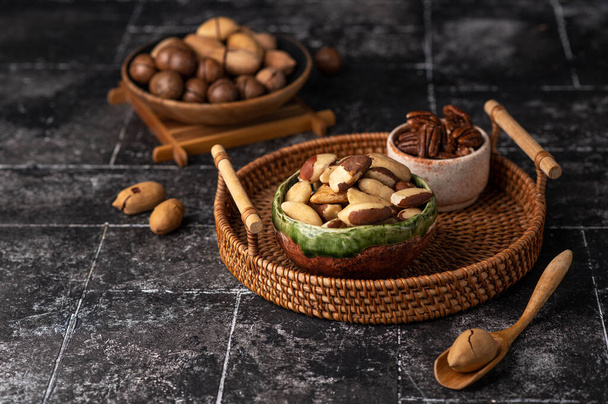 Various Nuts in wooden bowl on dark background. Free space for your text. - Fotoğraf, Görsel