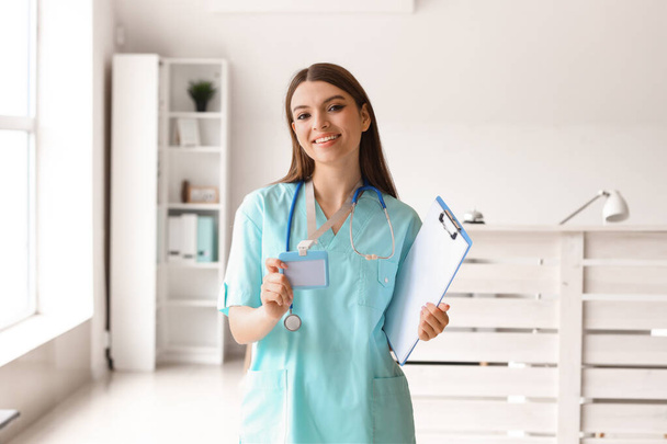 Female medical intern with clipboard at hospital - 写真・画像