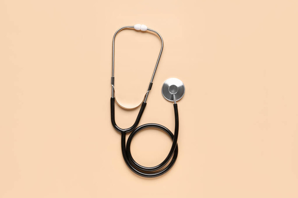 Modern stethoscope on beige  background - Фото, изображение