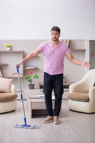 Young contractor cleaning the house - Foto, Bild