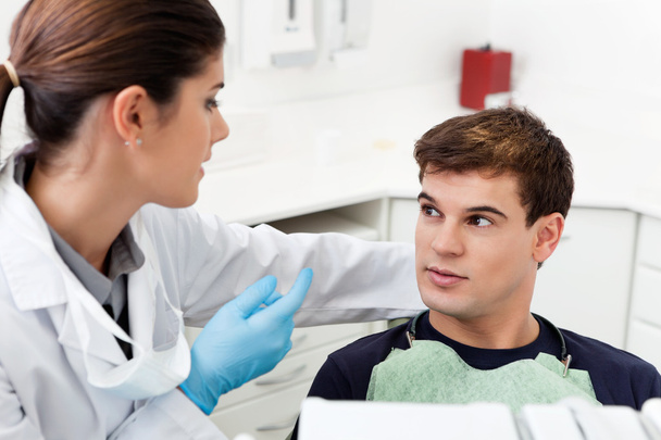 Dentist having conversation with patient - Valokuva, kuva