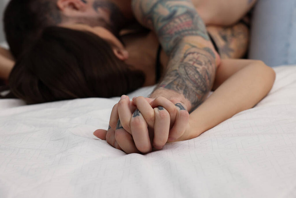 Passionate couple having sex on bed, closeup - Фото, изображение