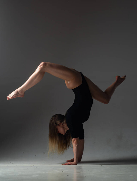 Flexible woman. Fit girl stretching and dancing. Stretching sexy flexible body. Flexible woman gymnast. Inspiration. Graceful ballet dancer. Art, motion, flexibility concept. Flexible female dancer - Photo, image
