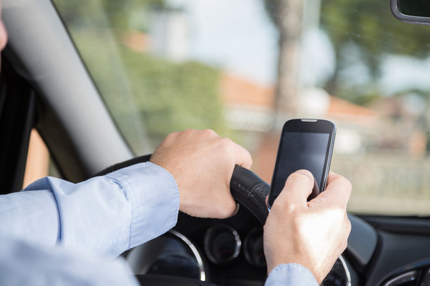 Man with mobile and driving - Photo, Image