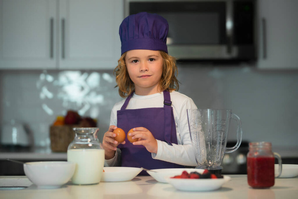 Child are preparing the dough, bake cookies in the kitchen - Fotó, kép