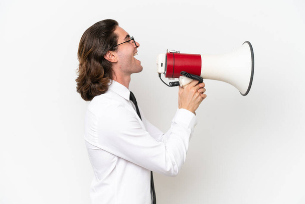 Business handsome man isolated on white background shouting through a megaphone - Photo, Image