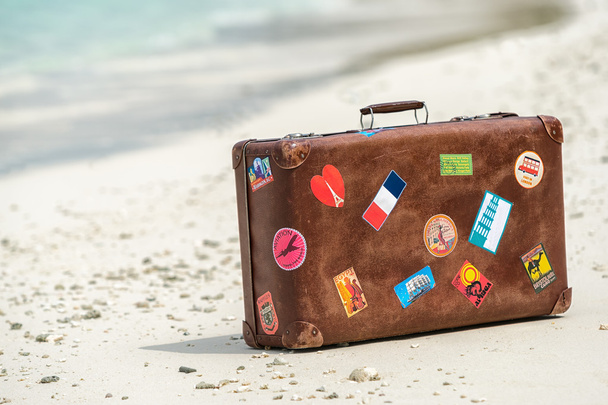Travel vintage suitcase is alone on a beach - Fotó, kép