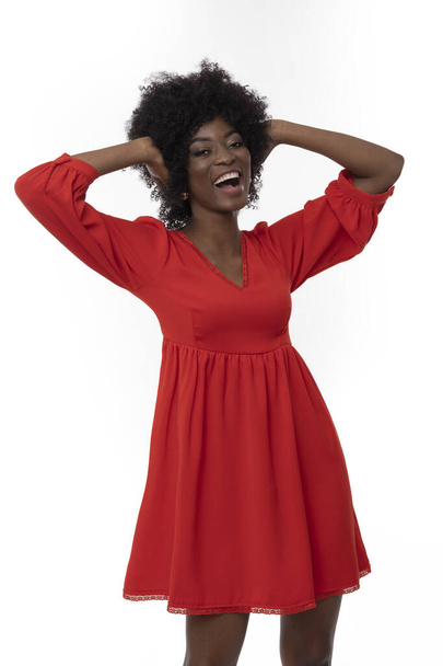 Positive young woman with afro hair style and dark skin in red dress on isolated white background. - Fotografie, Obrázek