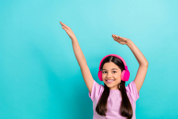 Photo of brunette hair preteen girl music sound earphones raised hands up vibe kids entertainment isolated on aquamarine color background. - Fotoğraf, Görsel