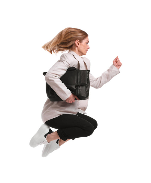Beautiful businesswoman with briefcase jumping on white background - Foto, afbeelding