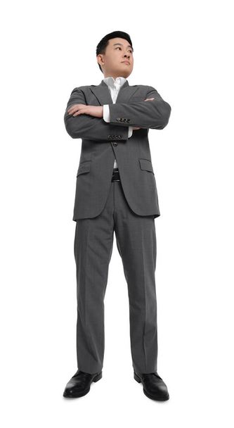 Businessman in suit posing on white background, low angle view - Zdjęcie, obraz