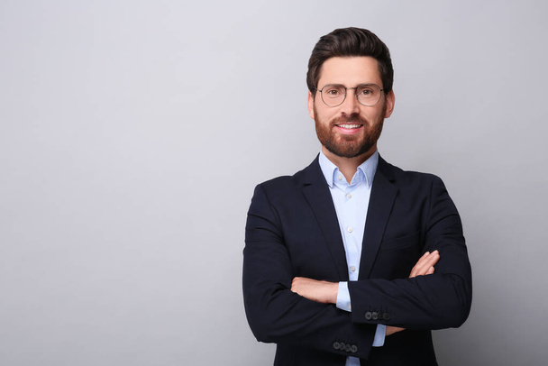 Portrait of handsome man in glasses on light grey background, space for text - Fotografie, Obrázek