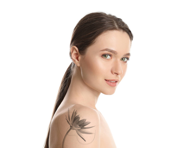 Young woman with beautiful flower tattoo on white background, side view - Фото, изображение