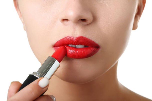 Woman applying red lipstick on white background, closeup - Fotoğraf, Görsel