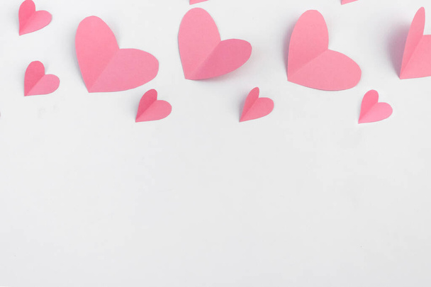 Pink paper hearts on a white background. Copy space. The concept of Valentine's Day. Flat lay. - Foto, immagini