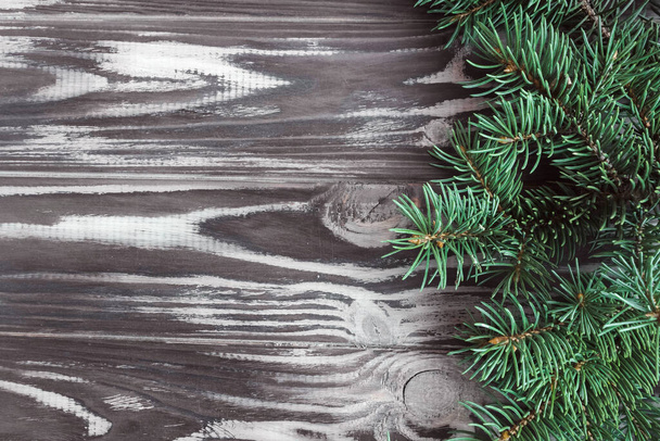 Spruce branches on a wooden background. Festive banner, postcard, invitation. New Year and Christmas concept. Copyspace. - Фото, зображення