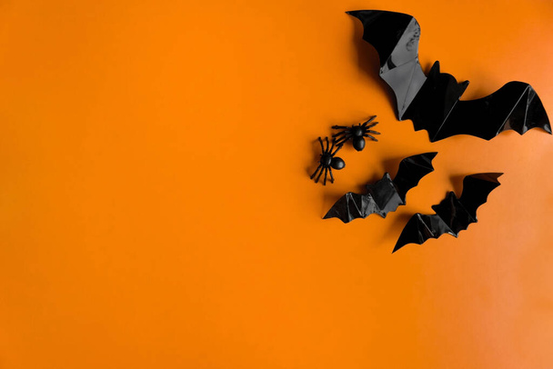 Halloween holiday. Flatly on an orange background. Postcard with bats. Copyspace. - Zdjęcie, obraz