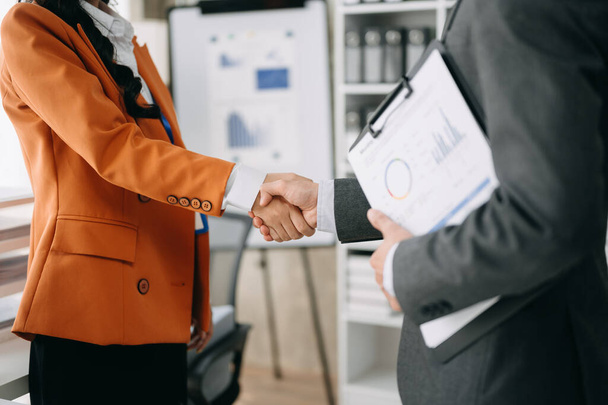 Two confident businesspeople shaking hands during a meeting in the office, success, dealing, greeting and partner - Foto, immagini
