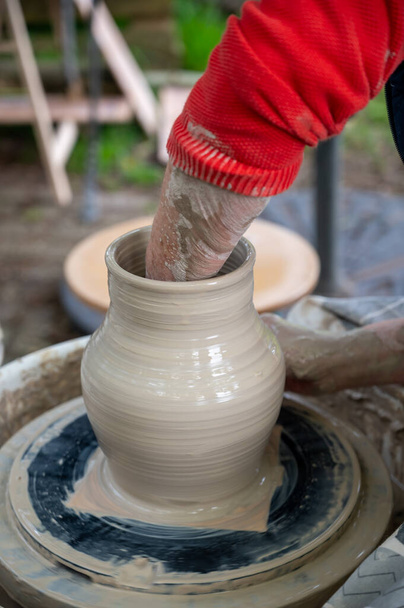 Making of mud pot on potters wheel during workshop outdoor in Netherlands - Photo, Image