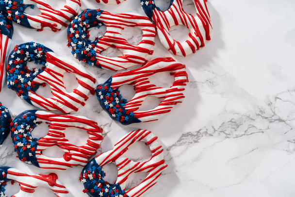 American flag. Red, white, and blue chocolate-covered pretzel twists. - Foto, Imagem