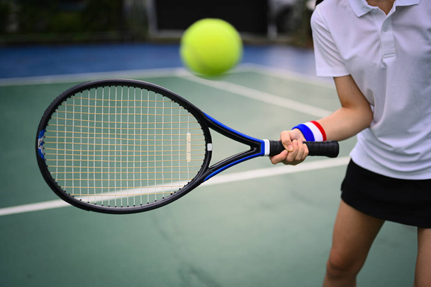 Shot of tennis player hitting ball with racket to return ball over net. Sport, fitness, training and active life concept. - Foto, Imagem