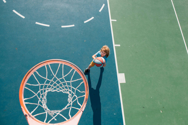 Kid playing basketball. Children sporty lifestyle. Kids sport activity - Zdjęcie, obraz