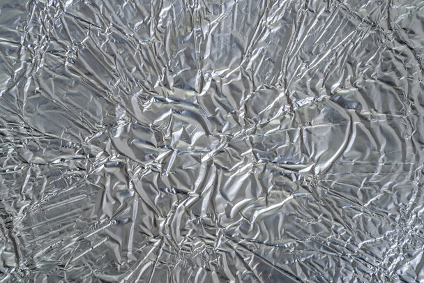 Macro texture of crumpled aluminum foil for the kitchen - 写真・画像
