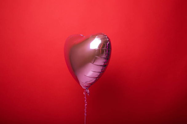 Balloon heart on a red isolated background. - 写真・画像