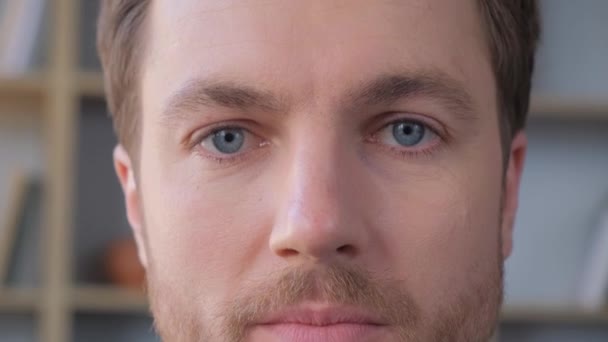 Close-up of the face of a European man looking into the camera and slowly closing his eyes. Portrait of a handsome young man. Vertical video - Video