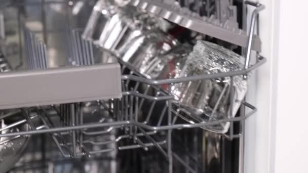Clean, shiny dishes in the dishwasher. The concept of cleanliness in the kitchen. Vertical video - Footage, Video