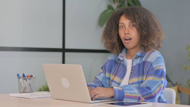 Shocked African American Woman Looking at Camera while Working in Office - Photo, Image