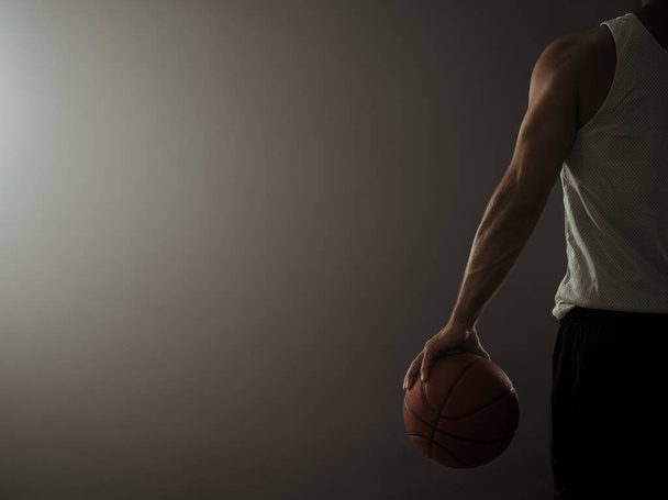 Rear view of a basketball player in the empty gym with copy space - Photo, Image