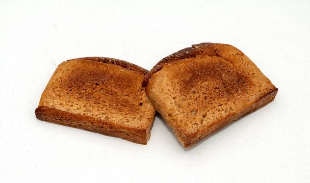 Two pieces of cut sliced bread baked in toaster - Fotó, kép