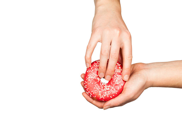 Female hands and a donut on a white background as a symbol of masturbation and foreplay (prelude) before sex. Touch the clitoris, erotic concept. - Photo, Image