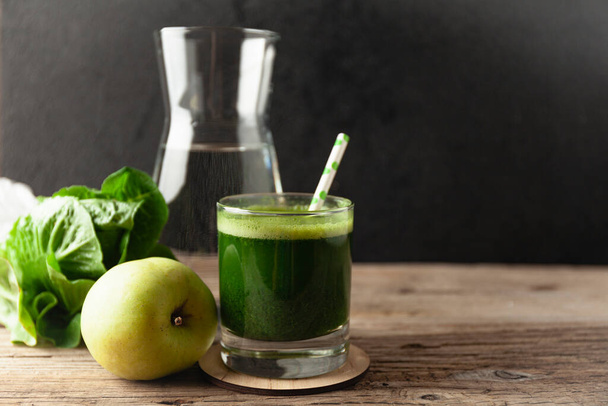 Healthy green smoothie on vintage wooden table. Fresh detox nutrient. - Fotó, kép