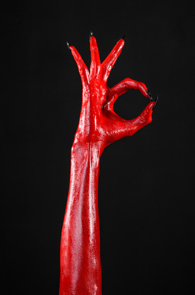 Red Devil's hands, red hands of Satan, Halloween theme, black background, isolated - Foto, immagini