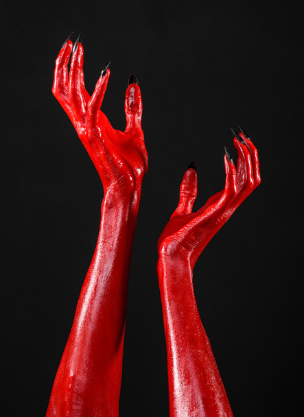 Red Devil's hands, red hands of Satan, Halloween theme, black background, isolated - Fotografie, Obrázek