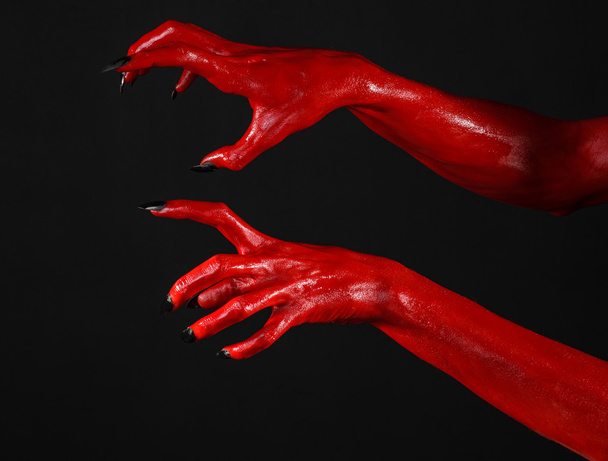 Red Devil's hands, red hands of Satan, Halloween theme, black background, isolated - Foto, imagen